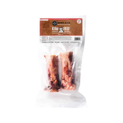 Package of raw beef marrow bones with visible branding on a white background