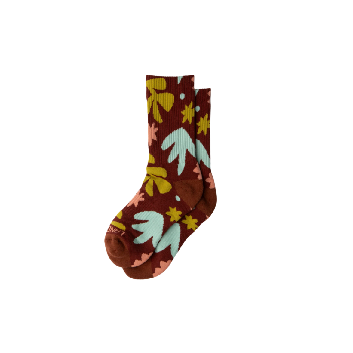 A colorful sock with a floral pattern on a brown background.