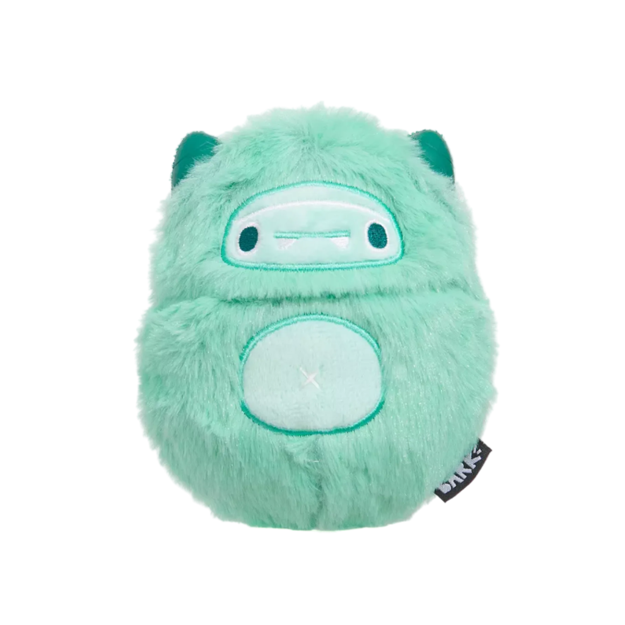 Green plush toy with a tag on a white background