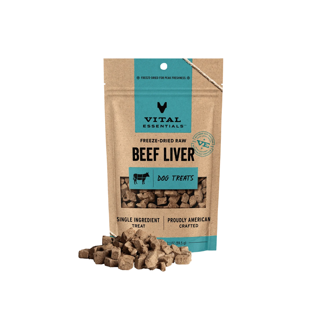 A stand-up pouch of Vital Essentials Beef Liver dog treats on a white background, with several brown cube-shaped treats spilled in front of the package.