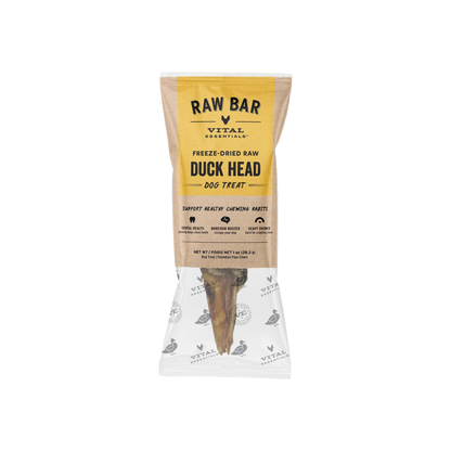 A packaged dog treat from Vital Essentials, specifically Raw Bar Freeze-Dried Raw Duck Head dog treat, shown in a clear bag with a kraft paper label and a visible bone-shaped treat inside.