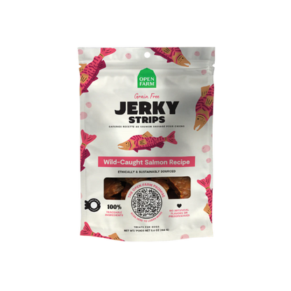 Packaging for Open Farm Jerky Strips with a white background featuring red and black text, and images of cows. The package is labeled as grain-free and gluten-free with a grass-fed beef recipe.