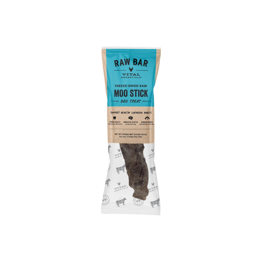 A RAW BAR dog treat stick by Vital Essentials, freeze-dried and moo-stick flavored, shown in its packaging with a turquoise and kraft paper design and a clear window displaying the dark brown treat inside.