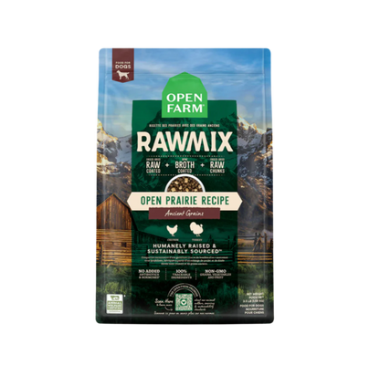A package of Open Farm RawMix dog food with a grain-free kibble formula. The bag is colorfully illustrated with images of dogs, a chef, and ingredients like meat and grains.