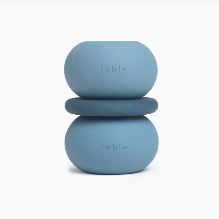 Two blue stacking toys with 'fable' branding on a white background