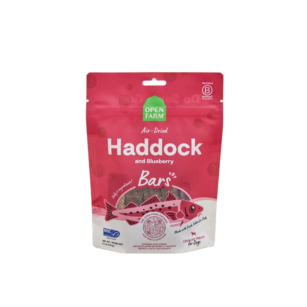 Pink package of Open Farm Haddock and Blueberry Bars on a light gray background