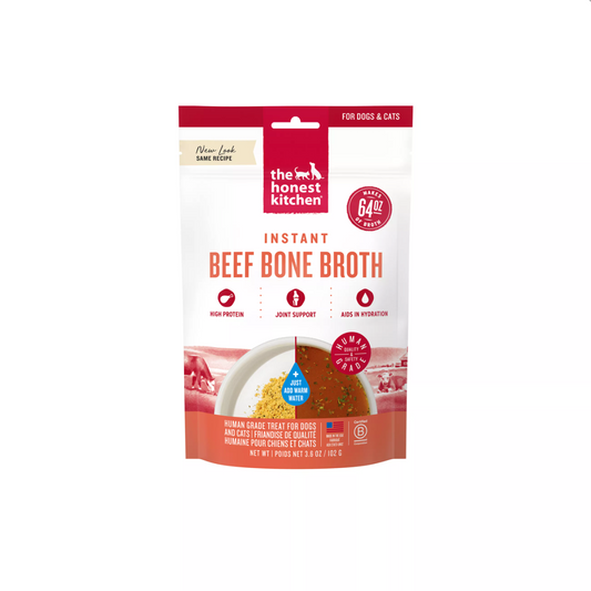 A stand-up pouch of The Honest Kitchen Instant Beef Bone broth for dogs and cats, featuring a white and red package design with a bowl of broth pictured on the front.