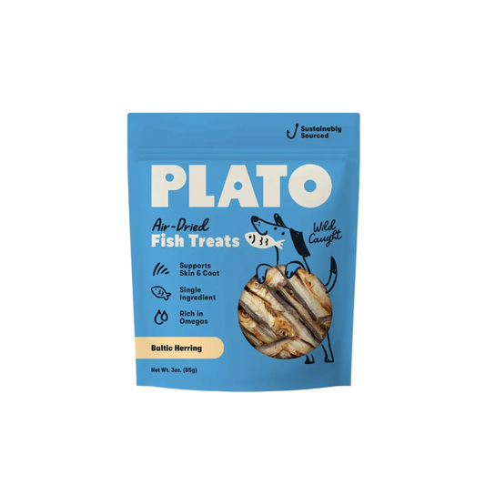 A blue stand-up pouch of Plato Air-Dried Fish Treats, Wild Caught, Baltic Herring flavor, shown against a solid pale beige background.